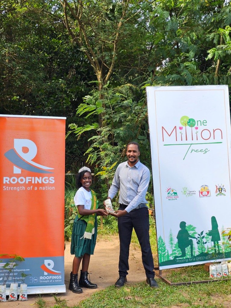 Green Ambassador with a Roofings Group partner beside the One Million Trees banner